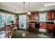 A view of the kitchen with granite countertops, dark wood cabinets, and modern appliances at 1027 Brookline Dr, Huntersville, NC 28078