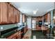 Spacious kitchen with dark wood cabinets, granite countertops, and stainless steel appliances at 1027 Brookline Dr, Huntersville, NC 28078