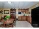 Functional kitchenette with wooden cabinets, appliances, and a cozy dining area at 1027 Brookline Dr, Huntersville, NC 28078