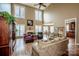 Bright, two-story living room with a fireplace, hardwood floors, and large windows at 1027 Brookline Dr, Huntersville, NC 28078