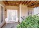 Covered patio with double doors, chairs, and greenery, providing a shaded outdoor retreat at 1027 Brookline Dr, Huntersville, NC 28078