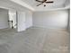 An empty bedroom features carpet floors, bright neutral-colored walls, and an open doorway at 111 Canada Dr, Statesville, NC 28677