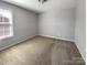 Bedroom with carpet and neutral walls with natural light streaming in through a window at 111 Canada Dr, Statesville, NC 28677