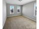 Bedroom features carpet, light walls, and a large window providing lots of natural light at 111 Canada Dr, Statesville, NC 28677