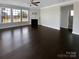 Open living room with fireplace, large windows, dark hardwood floors, and lots of natural light at 111 Canada Dr, Statesville, NC 28677