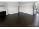 Spacious living room with hardwood floors, a fireplace, a ceiling fan, and a staircase at 111 Canada Dr, Statesville, NC 28677