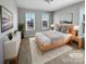 Staged bedroom featuring soft carpet, neutral walls, and a large windows for natural light at 111 Canada Dr, Statesville, NC 28677