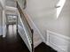 A carpeted staircase with dark wood railings and white risers leads to the home's upper level at 111 Canada Dr, Statesville, NC 28677