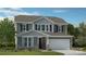 Charming two-story home with gray siding, stone accents, and a two-car garage at 117 Goorawing Ln, Mooresville, NC 28115