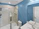 Bathroom featuring a glass-enclosed shower, blue walls, a white vanity, and modern fixtures at 1300 Lena St, Monroe, NC 28112