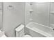 A bathroom features a toilet, towel rack, and a combined bathtub and shower with a white enclosure at 1300 Lena St, Monroe, NC 28112