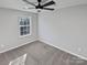 Neutral bedroom with a ceiling fan and large window at 1300 Lena St, Monroe, NC 28112