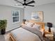 Neutral bedroom with a ceiling fan, large window, and tasteful decor, creating a serene and inviting atmosphere at 1300 Lena St, Monroe, NC 28112