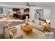 Bright living room showcasing neutral furnishings, a ceiling fan, and an open floor plan connecting to the kitchen at 1300 Lena St, Monroe, NC 28112