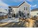 Back of a two-story home featuring a sliding glass door, fenced-in yard, and concrete patio at 1300 Lena St, Monroe, NC 28112