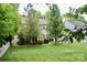 Expansive backyard with a well-maintained lawn and established trees, perfect for outdoor activities at 13127 Centennial Commons Pkwy, Huntersville, NC 28078