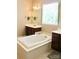 Relaxing bathroom with a large tub and a window view at 13127 Centennial Commons Pkwy, Huntersville, NC 28078