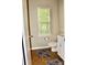 Cozy half bathroom featuring a window view, tile floor and modern fixtures at 13127 Centennial Commons Pkwy, Huntersville, NC 28078