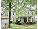 Charming two-story home featuring a manicured lawn and a welcoming front porch at 13127 Centennial Commons Pkwy, Huntersville, NC 28078