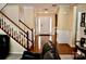 Bright foyer with hardwood floors, staircase, and paneled walls at 13127 Centennial Commons Pkwy, Huntersville, NC 28078