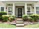 Inviting front porch with decorative columns and manicured landscaping at 13127 Centennial Commons Pkwy, Huntersville, NC 28078