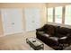 Inviting living room with plush leather sofa, coffee table, and closet at 13127 Centennial Commons Pkwy, Huntersville, NC 28078