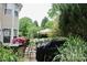 Well-appointed patio features a grill, dining set, and lush greenery, ideal for outdoor entertaining at 13127 Centennial Commons Pkwy, Huntersville, NC 28078