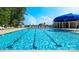 Expansive community pool featuring lap lanes and comfortable seating under shaded umbrellas at 133 Calvin Creek Dr, Troutman, NC 28166