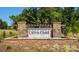 Elegant entrance sign for Calvin Creek, showcasing stone architecture and lush landscaping at 133 Calvin Creek Dr, Troutman, NC 28166