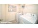 Well-organized laundry room with washer, dryer, and storage shelves for convenience at 133 Calvin Creek Dr, Troutman, NC 28166