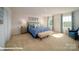 Serene main bedroom featuring a tufted headboard bed, complemented by natural light and soft colors at 133 Calvin Creek Dr, Troutman, NC 28166