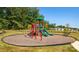 Inviting community playground with colorful play structures and a surrounding wood chip safety zone at 133 Calvin Creek Dr, Troutman, NC 28166