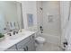 Modern bathroom features subway tile in the shower and grey cabinets at 2011 Mantle Ridge Dr # 193, Wesley Chapel, NC 28079