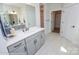 Bathroom showcasing a vanity with gray cabinets, white countertop, and tiled floors at 2011 Mantle Ridge Dr # 193, Wesley Chapel, NC 28079