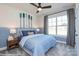 Comfortable bedroom features a large window, ceiling fan and nautical decorations at 2011 Mantle Ridge Dr # 193, Wesley Chapel, NC 28079