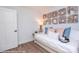 Cozy bedroom features a daybed with throw pillows and decorative wood block wall art at 2011 Mantle Ridge Dr # 193, Wesley Chapel, NC 28079