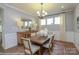 Dining room featuring a wood table, an area rug, and a modern chandelier at 2011 Mantle Ridge Dr # 193, Wesley Chapel, NC 28079