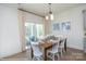 Dining room features a wood table with white chairs and a sliding glass door for natural light at 2011 Mantle Ridge Dr # 193, Wesley Chapel, NC 28079