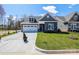 Charming home boasting stone accents, a two car garage and a well-manicured lawn at 2011 Mantle Ridge Dr # 193, Wesley Chapel, NC 28079