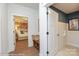 Entryway hallway with wooden floors, a bench, and a view into another room at 2011 Mantle Ridge Dr # 193, Wesley Chapel, NC 28079