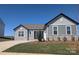 Beautiful single-story home featuring stone accents, gray siding, manicured lawn, and a paved driveway at 2063 Fordhill St, Rock Hill, SC 29732