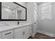 Modern bathroom features white cabinetry, marble countertop, and a sleek, black-framed mirror at 2078 Fordhill St, Rock Hill, SC 29732