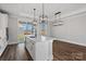 Bright kitchen island with modern pendant lighting and stainless faucet overlooking the backyard at 2078 Fordhill St, Rock Hill, SC 29732