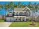 Charming two-story home featuring a manicured lawn, two-car garage and a welcoming front porch at 225 Yale Pl, Fort Mill, SC 29707