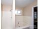 Bright bathroom featuring a bathtub and shower combo with natural lighting and a soaking tub at 3001 Austin Chaney Rd, Monroe, NC 28110