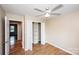 Bright bedroom featuring a ceiling fan, wood floors, closet, and fresh paint at 3001 Austin Chaney Rd, Monroe, NC 28110