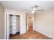 This bedroom offers wood-look floors, a ceiling fan and a closet with built-in shelves at 3001 Austin Chaney Rd, Monroe, NC 28110