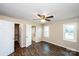 Bright bedroom features a ceiling fan, windows, and a closet, with warm tones and wood-look floors at 3001 Austin Chaney Rd, Monroe, NC 28110