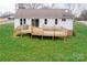 View of the house's rear exterior and wooden deck overlooking a large yard at 3001 Austin Chaney Rd, Monroe, NC 28110