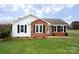 Inviting single-story home showcasing a combination of vinyl siding and brick, complemented by lush green grass at 3001 Austin Chaney Rd, Monroe, NC 28110